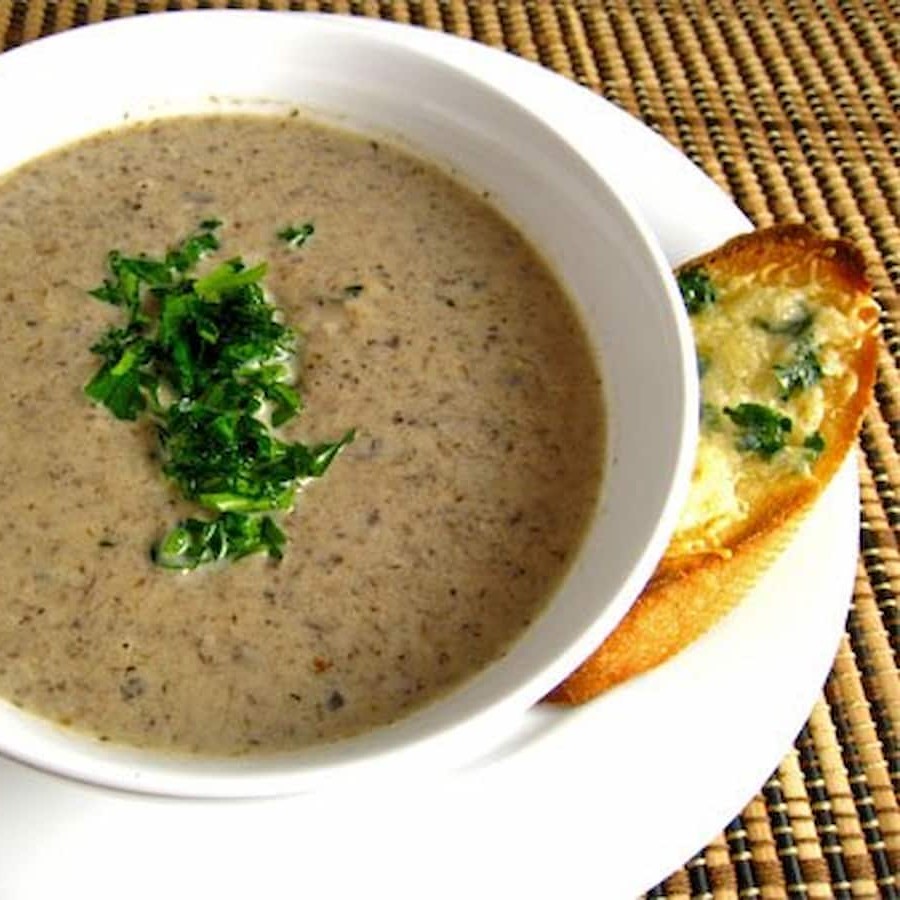 Cream of mushroom soup with a small loaf of garlic bread